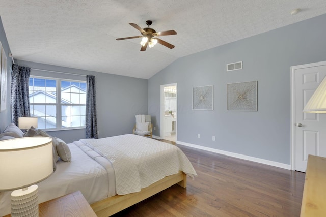 bedroom featuring visible vents, lofted ceiling, a textured ceiling, and wood finished floors