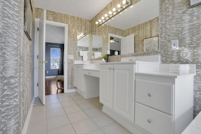 full bathroom with tile patterned floors, baseboards, vanity, and wallpapered walls