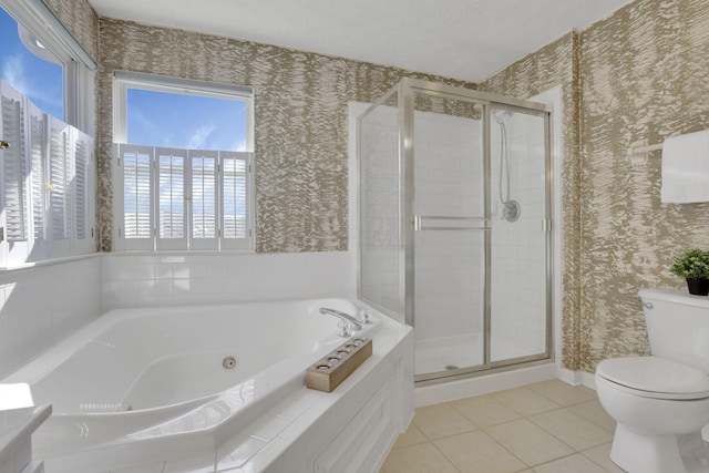 bathroom with wallpapered walls, toilet, and a stall shower