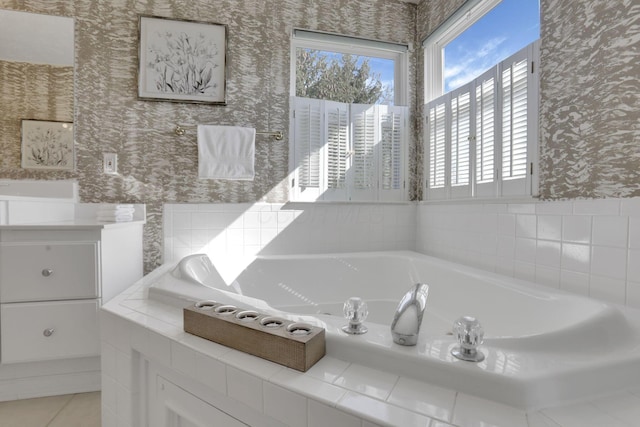 full bathroom featuring wallpapered walls, a bath, and vanity