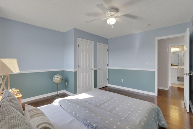 bedroom featuring baseboards, wood-type flooring, a textured ceiling, and a ceiling fan