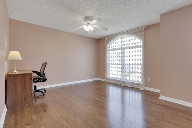 office area featuring baseboards, wood-type flooring, and ceiling fan