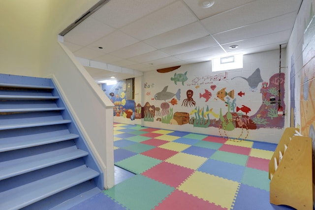 playroom featuring a paneled ceiling