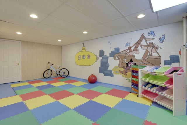 game room featuring recessed lighting, concrete block wall, and a paneled ceiling