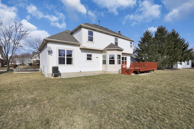 rear view of house with a patio, central AC, a yard, a shingled roof, and a wooden deck