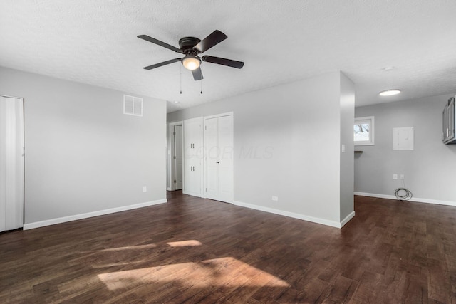 interior space featuring visible vents, multiple closets, baseboards, and dark wood-style floors