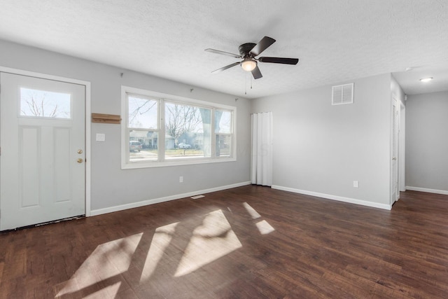 entrance foyer with wood finished floors, visible vents, baseboards, ceiling fan, and a textured ceiling