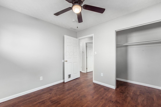 unfurnished bedroom with a closet, baseboards, and wood finished floors