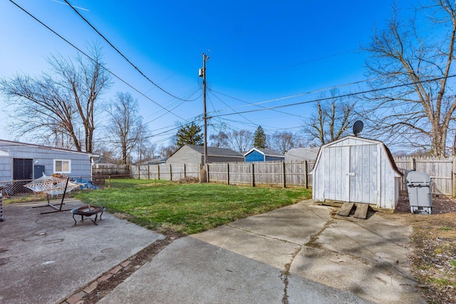 view of yard featuring a patio, a fire pit, and a fenced backyard