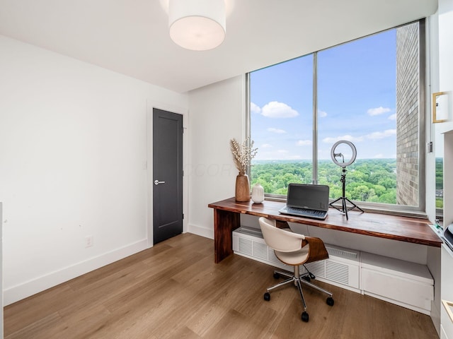 office area with baseboards and wood finished floors