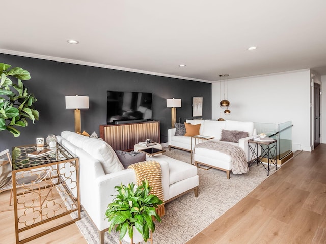 living area featuring crown molding, recessed lighting, wood finished floors, and baseboards