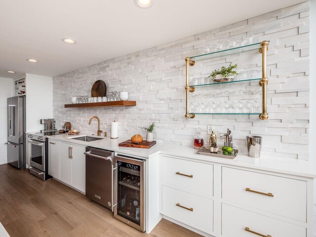 kitchen featuring a sink, wine cooler, decorative backsplash, stainless steel appliances, and open shelves