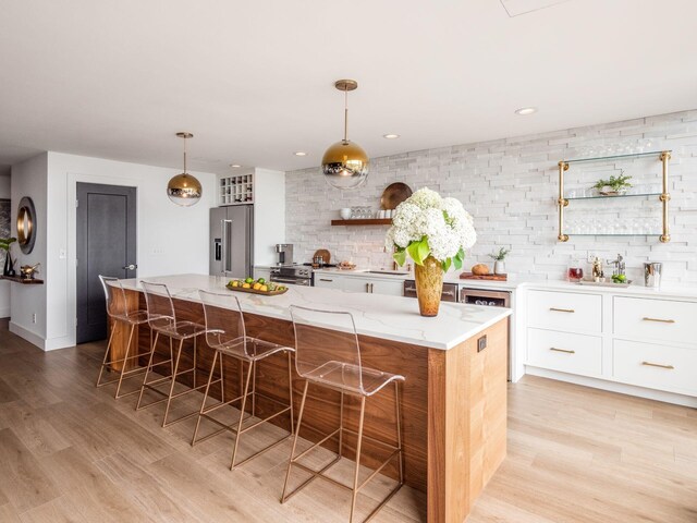 kitchen featuring backsplash, white cabinetry, stainless steel appliances, and open shelves