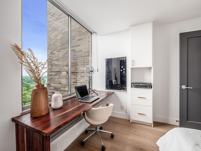 home office featuring baseboards and light wood-style flooring