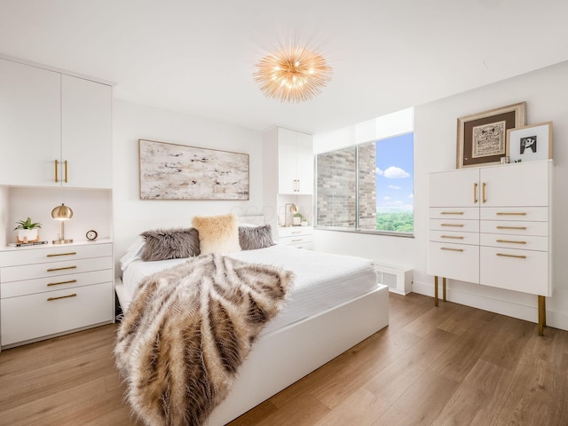 bedroom with visible vents and light wood finished floors