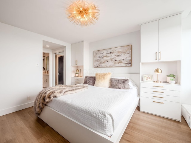 bedroom with light wood finished floors and baseboards