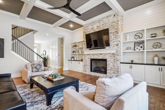 living room with stairway, wood finished floors, coffered ceiling, and ceiling fan