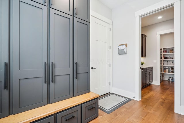 mudroom featuring recessed lighting, baseboards, and light wood finished floors