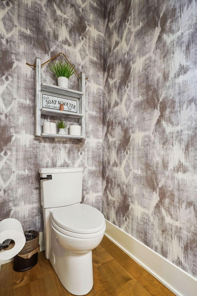 bathroom with toilet and wood finished floors