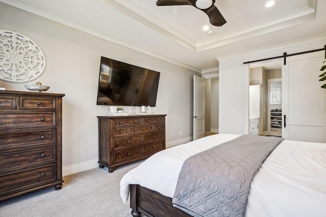 bedroom with light carpet, ornamental molding, recessed lighting, a barn door, and a raised ceiling