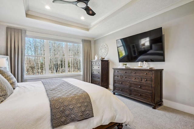 bedroom featuring baseboards, a raised ceiling, ceiling fan, and carpet flooring