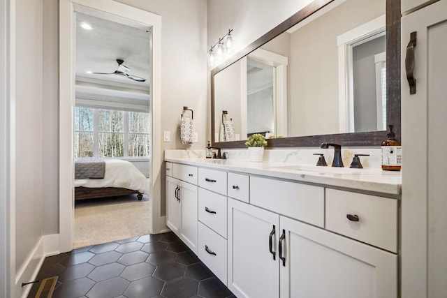 ensuite bathroom featuring ceiling fan, double vanity, tile patterned floors, ensuite bath, and a sink