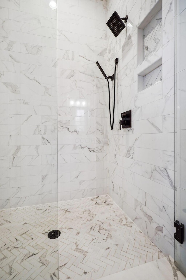 bathroom with a tile shower