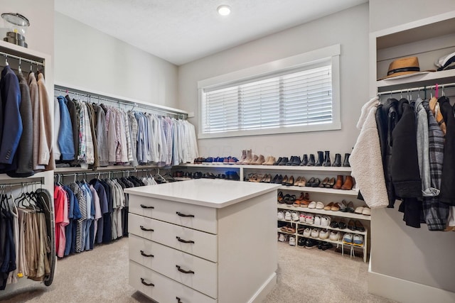 walk in closet with carpet