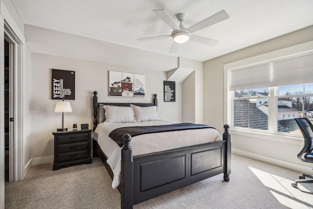 bedroom with baseboards, carpet floors, and a ceiling fan