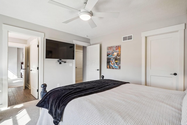 bedroom with visible vents, ceiling fan, and wood finished floors