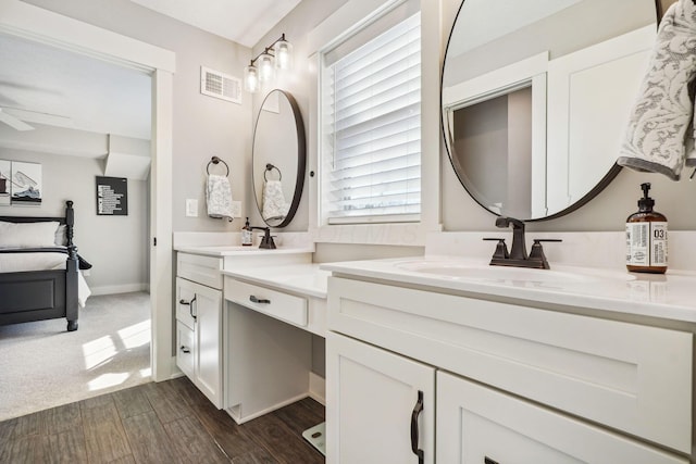 full bath featuring ceiling fan, double vanity, visible vents, and a sink