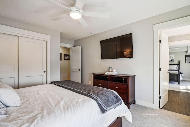 bedroom featuring a closet, carpet flooring, ceiling fan, and baseboards