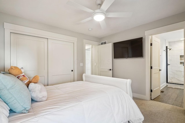 bedroom with visible vents, baseboards, a closet, ensuite bathroom, and carpet flooring