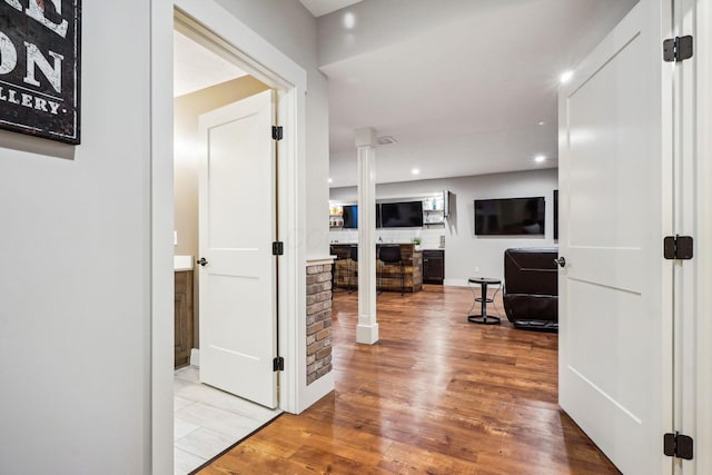 hallway with recessed lighting and wood finished floors