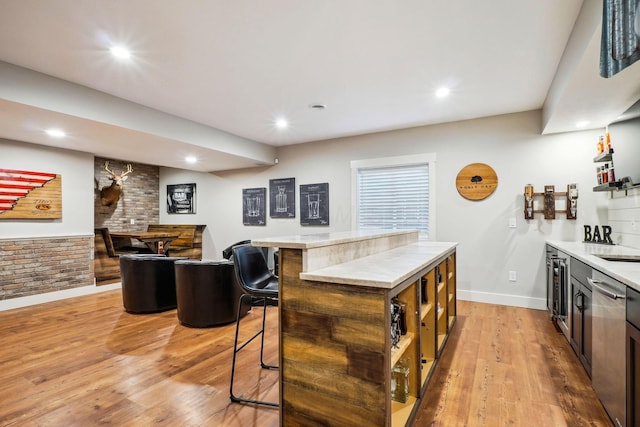 kitchen with light countertops, light wood-style flooring, and recessed lighting