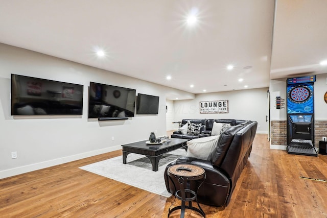 living area featuring recessed lighting, baseboards, and wood finished floors