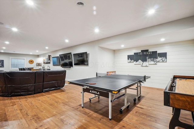 recreation room with recessed lighting, visible vents, and light wood finished floors