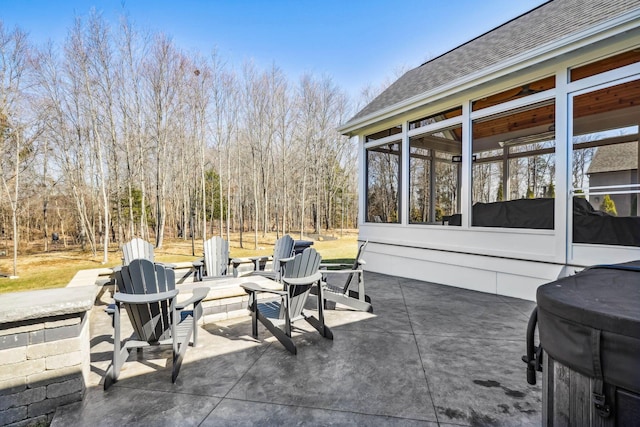 view of patio featuring a sunroom