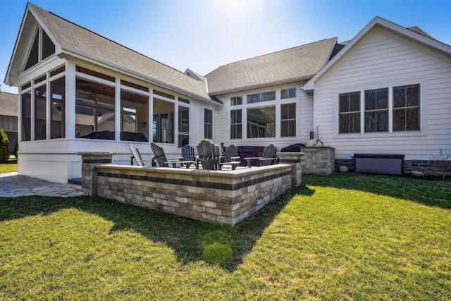 back of house with a patio, a lawn, a sunroom, and roof with shingles