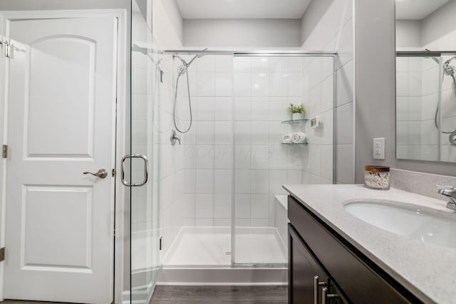 full bathroom featuring a shower stall and vanity