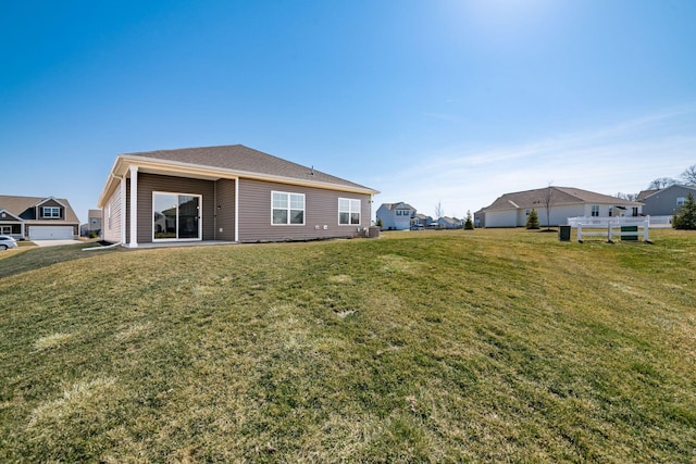 rear view of house with a yard