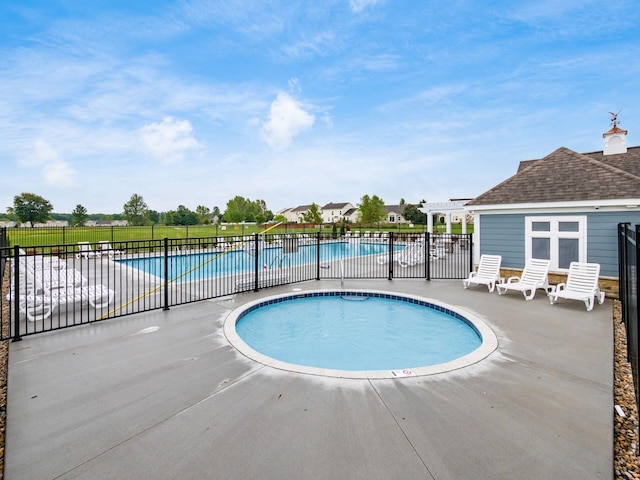 pool with a patio, fence, and a pergola