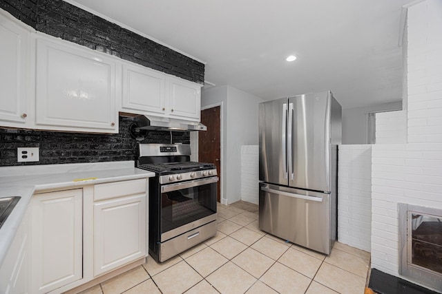 kitchen featuring light tile patterned floors, stainless steel appliances, light countertops, under cabinet range hood, and white cabinetry