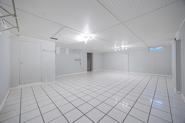 finished basement featuring light tile patterned floors