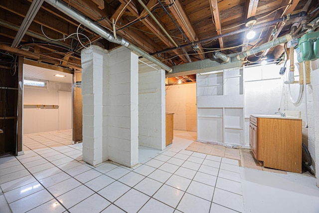 unfinished basement featuring light tile patterned floors