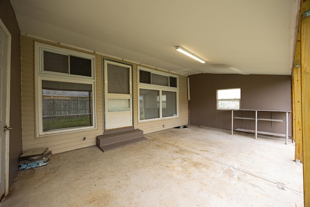 spare room featuring unfinished concrete floors