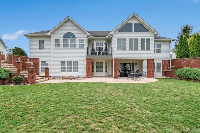 back of property featuring a lawn, a patio, and fence