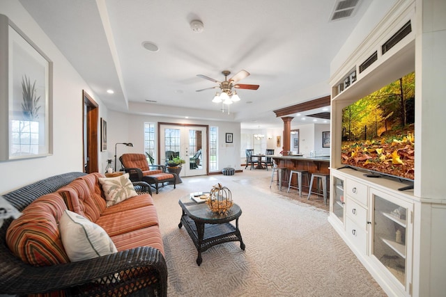living room featuring visible vents, light carpet, recessed lighting, ceiling fan, and ornate columns