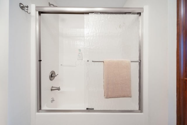 bathroom with shower / bath combination with glass door
