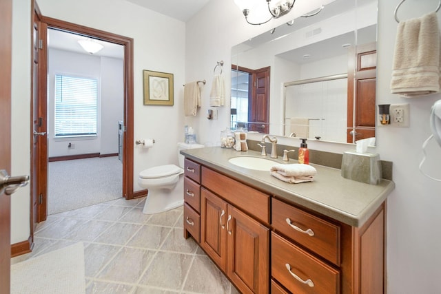 bathroom with a shower with shower door, baseboards, toilet, and vanity